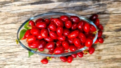 cornelian cherry, wild fruit into glass bowl