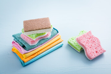 Assortment of different sponges and cleanings rags, with fiber cloth and duster microfiber cloth