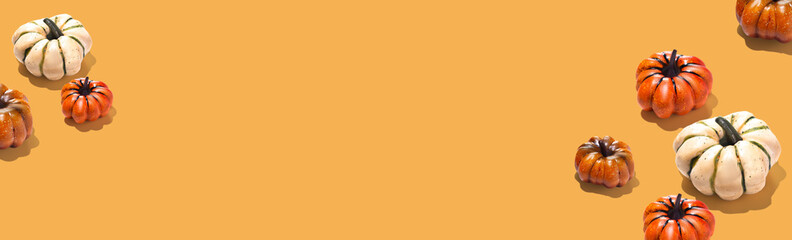 Pumpkin pattern creative on orange yellow background long banner minimal copy space