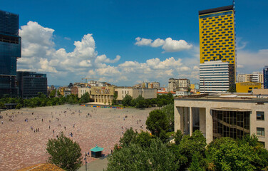 Skanderbeg Square in Tirana,Albania,viewed from the top of Clock Tower over the roof of Ethem Bey Mosque.Centre-National History Museum with the iconic Albanians mosaic. Left-Eyes of Tirana skyscraper