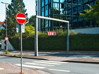 A road that leads into the tunnel, with a warning sign and marking that only a certain height of vehicle can pass through