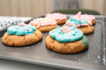 Beautifully decorated cookies with colorful frosted sugar and adorned with sprinkles on a tray