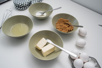 Baking ingredients: eggs, sugar, butter, milk and oil for homemade cookies.
