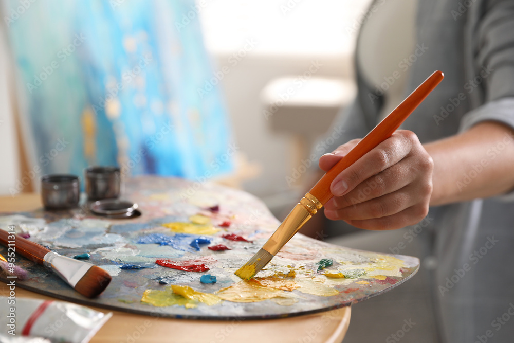 Poster Woman with brush using palette at table indoors, closeup