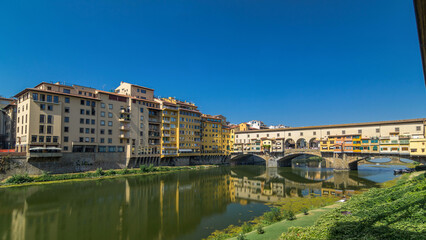 The Ponte Vecchio on a sunny day timelapse hyperlapse, a medieval stone segmental arch bridge over the Arno River, in Florence, Italy