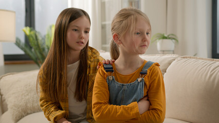 Upset angry little Caucasian children girls sisters kids friends quarrel daughters apology ask for...