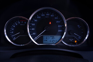 Fototapeta premium The console panel displays the car's information and speed and the fuel gauge is red.