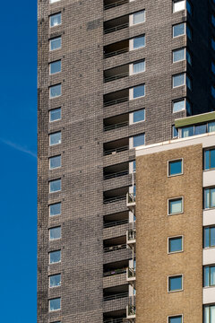 Contemporary high-rise building with a combination of brick and glass elements, offering a modern urban living environment with an emphasis on clean lines and functionality.