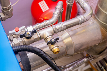 Boiler equipment close-up. Pipes from gas heating system. Pipeline is connected to gas tank. Gas boiler equipment for private home. Concept for sale and repair of heating systems. Boiler tech