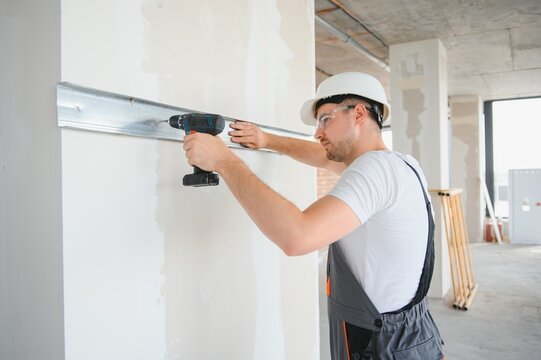 man fasten metal profile frame to the wall for draywall bulkhead