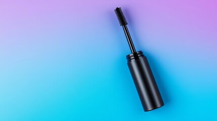 Black mascara wand on a blue and purple background.