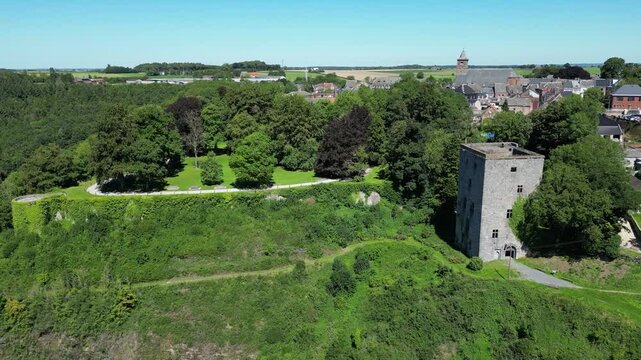 medieval tower keep with remains of the city walls forward aerial drone panning shot sunny sunshine weather Tour Salamandre in Beaumont belgium