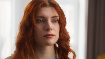 Fototapeta premium Frustrated Caucasian woman sad female disappointed girl portrait posing bored lady looking at camera negative facial expression close up pensive model upset emotion at home stress insurance mortgage