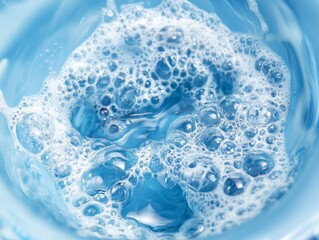 Naklejka premium Close-up of foamy blue water, capturing the essence of a powerful cleaning agent, with intricate bubbles reflecting light, symbolizing the effectiveness of the detergent in achieving a deep clean.