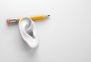 Surreal image of a ear on wall with a pencil. Project manager and focus concept.