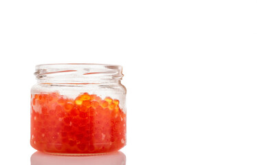 Red caviar in a glass jar, macro, isolated on a white background
