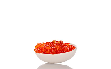 Red caviar in a ceramic plate, macro, isolated on a white background