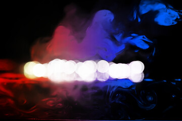 colorful smoke on dark background. Color steam on a black background. Red and blue smoke. Copy space.