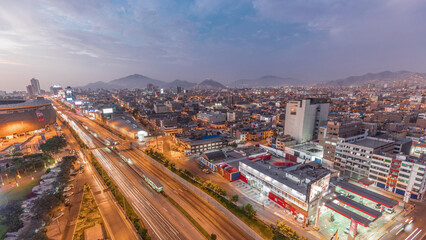 Obraz premium Aerial view of Via Expresa highway and metropolitan bus with traffic day to night timelapse. Lima, Peru
