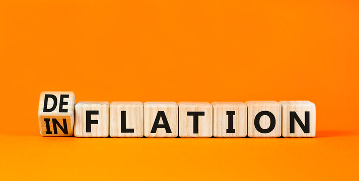 Deflation or inflation symbol. Concept word Deflation Inflation on beautiful wooden cubes. Beautiful orange table orange background. Business deflation inflation concept. Copy space