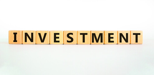 Investment symbol. Concept word Investment on beautiful wooden blocks. Beautiful white background. Business investment concept. Copy space.