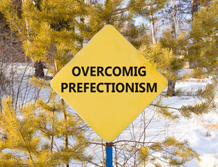 Overcoming perfectionism symbol. Concept words Overcoming perfectionism on beautiful yellow road...