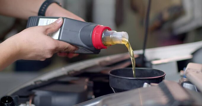 Add new engine oil to the engine. Extreme close up.New engine oil golden yellow.Footage 60P