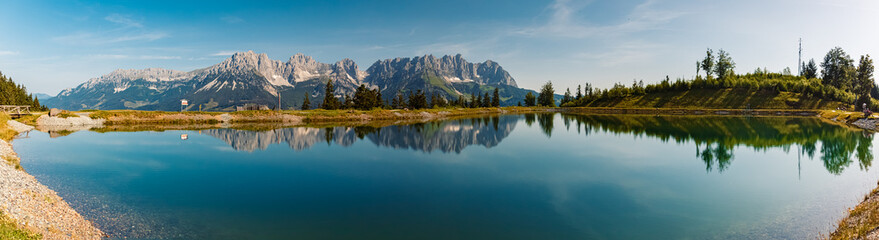 High resolution stitched alpine summer panorama with reflections and Mount Wilder Kaiser at Mount Astberg, Going, Kitzbuehel, Tyrol, Austria