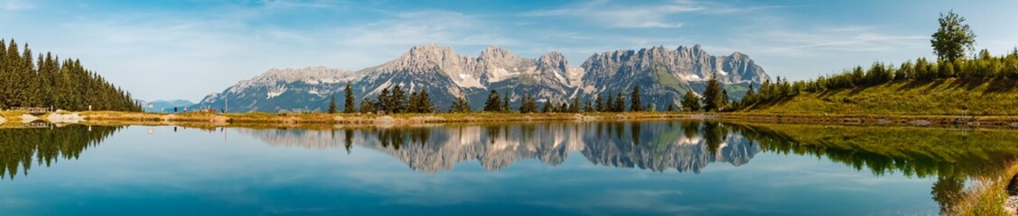 High resolution stitched alpine summer panorama with reflections and Mount Wilder Kaiser at Mount Astberg, Going, Kitzbuehel, Tyrol, Austria