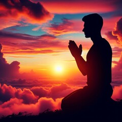 Prayer concept. Silhouette of a young man in a praying pose. Set against a vibrant sunset sunrise sky. Clasped hands. Also related to gospel, testimony, deliverance, providence, mercy
