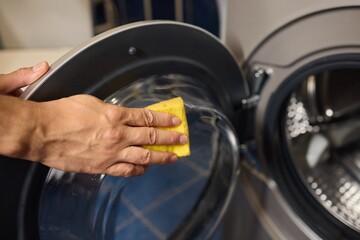 To effectively clean a washing machine door, use a cloth for a thorough cleanliness and shine