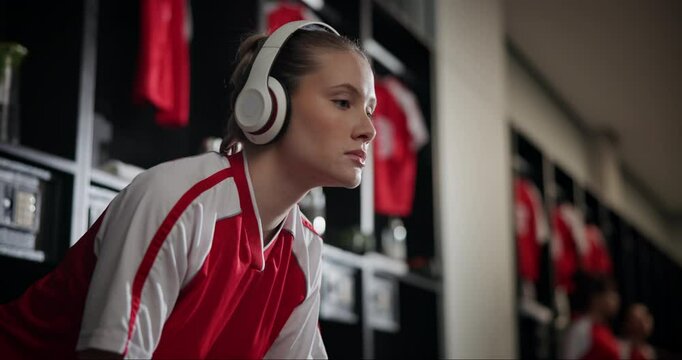 Headphones, music and woman soccer player with break in locker room for match, game or tournament. Audio, podcast and young female athlete with smartphone, competition playlist and football training