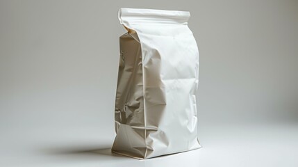 A plain, crinkled, white packaging bag standing upright on a neutral background, ideal for mockups, branding, or showcasing product packaging design,