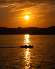 Fishing boat on the sea at sunset. Beautiful summer landscape.