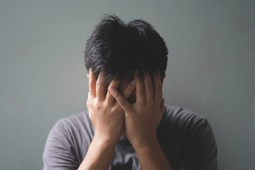 Fototapeta premium Worried fatigued mature business man having headache at home, tiired busy 30s middle aged businessman feeling stress at workplace looking at laptop computer in office and massaging his pain area.