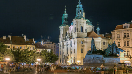 Obraz premium Baroque St. Nicholas' Cathedral on the Oldtown Square in Prague with monument Jan Hus illuminated at night timelapse