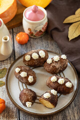 Chocolate rum potato cake with pumpkin on rustic background, homemade vegan dessert. Traditional Eastern European dish with cocoa and butter. Chocolate sweets filled with marzipan.