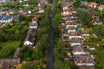 Aerial drone shot over cars driving on the road in Bishops Stortford in England
