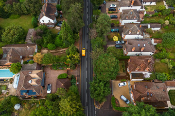 Aerial drone shot over cars driving on the road in Bishops Stortford in England