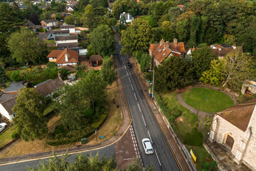 Aerial drone shot over cars driving on the road in Bishops Stortford in England