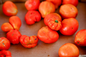 Fresh organic red tomatoes displayed at farmers market