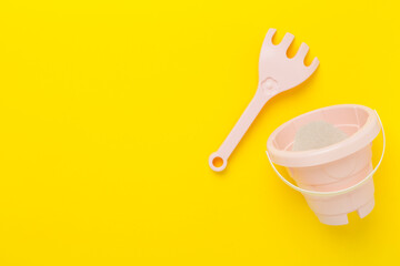 Cute toys for playing with sand on color background, top view