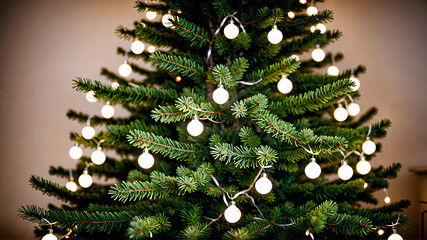 A close-up of a beautifully decorated Christmas tree branch adorned with red and gold ornaments and twinkling lights.