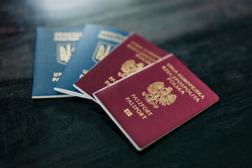 Two passports, one Polish and one Ukrainian, are lying on a table in a home, symbolizing migration and citizenship