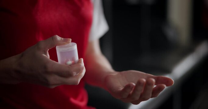 Cheat, hands or athlete in locker room with pills for game, illegal steroids or anxiety medication. Football fitness, sports person or soccer player ready for match with performance enhancement drugs