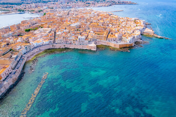 Aerial of Ortigia island, old town with turquoise sea of Syracuse. Small island on Sicily, Italy.