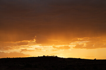 A stunning sunset over a ridge in silhouette.