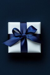 Elegant White Gift Box with Navy Blue Ribbon on Solid Navy Background for Sophisticated Occasions