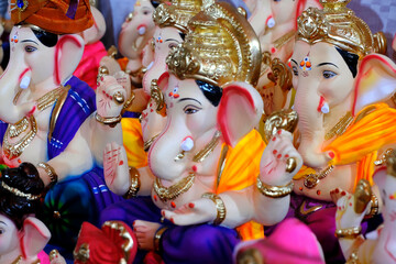 Fototapeta premium 31 August 2024, Pune, India, Ganesha or Ganapati for sale at a shop on the event of Ganesh festival in India, Eco friendly God Ganesha Statue made from clay.