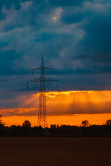 Summer sunset with overland high voltage lines near Tabertshausen, Aholming, Deggendorf, Bavaria, Germany